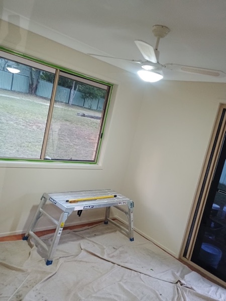 A room with new plaster on the walls and a trestle standing against one of them