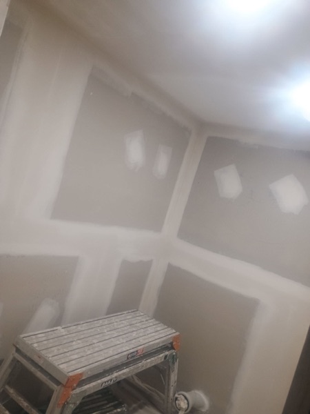A ceiling with fresh plaster over the sheet joins and screw lines