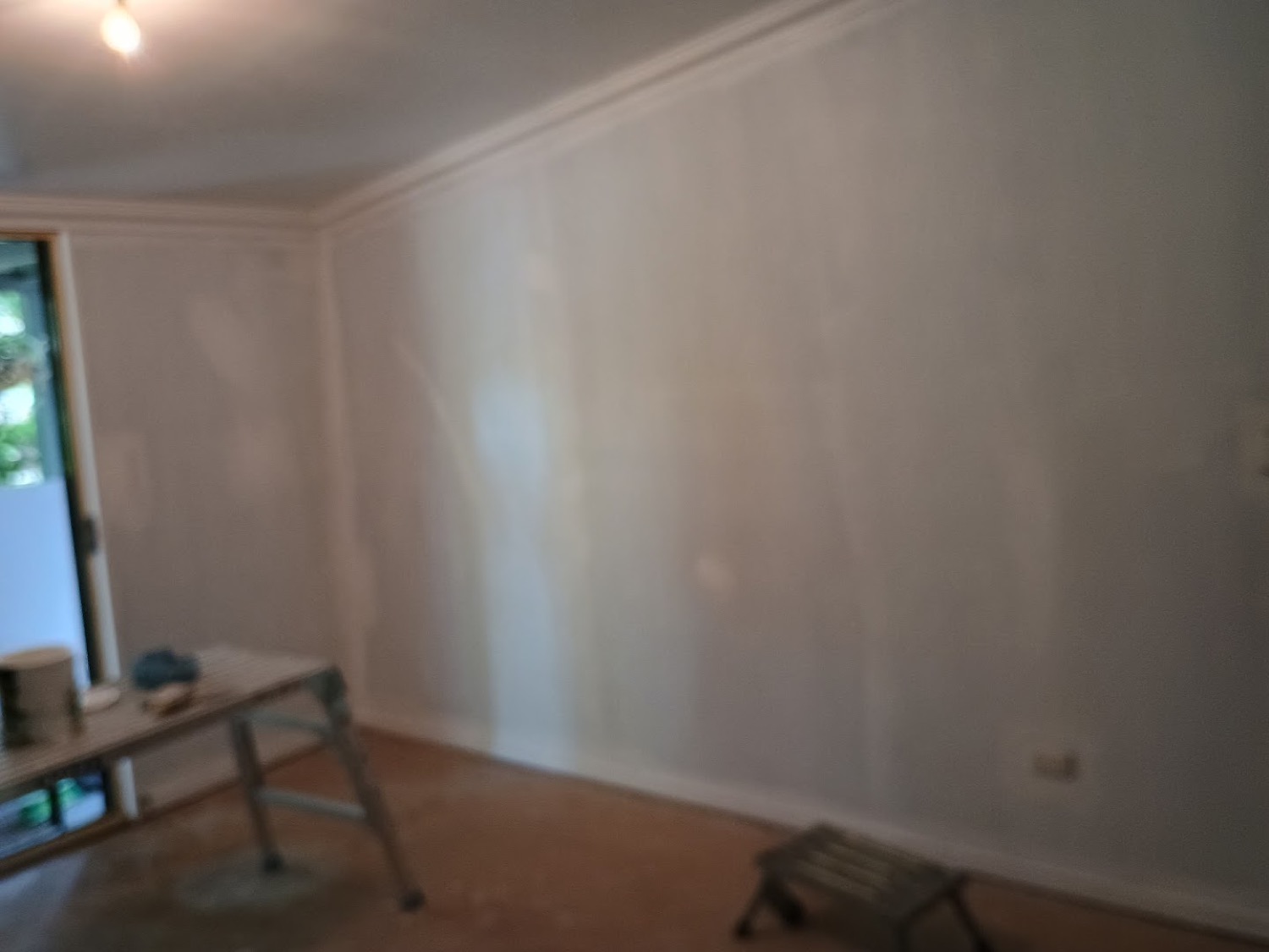 A room with freshly set gyprock walls and ceiling