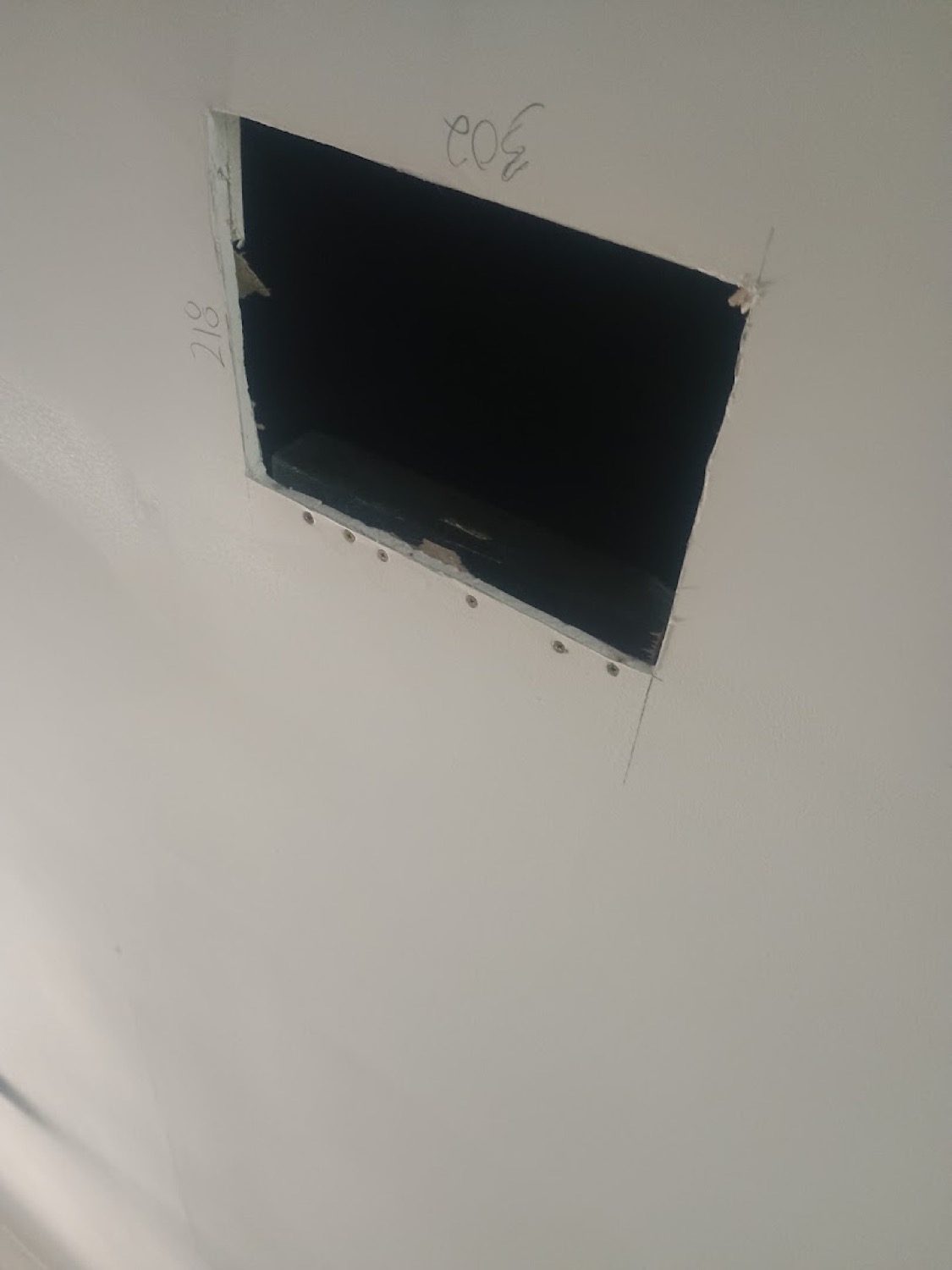A square section cut out of a plasterboard wall ready for a patch