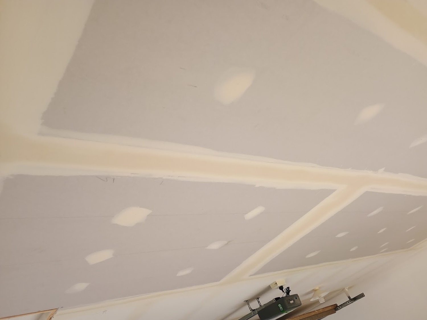 A ceiling with set plaster running along each sheet join